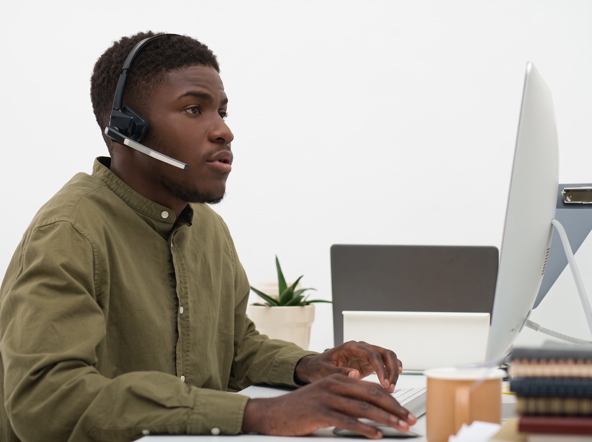 Customer support agent wearing a headset at a desk