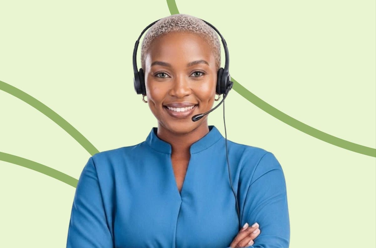 A smiling customer support agent wearing a headset